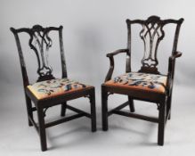 A set of eight Chippendale style mahogany dining chairs, (one arm, seven single), carved crest rails