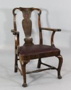A George II walnut open armchair, with vase shaped splat and drop in seat, on cabriole leg with