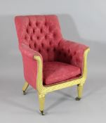 A Regency giltwood tub chair, with buttonback red floral upholstery, on turned and fluted legs