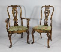 A set of six Queen Anne style carved walnut dining chairs, including two with arms, with pierced