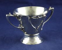 A stylish Edwardian Art Nouveau Scottish silver two handled cup, of planished flared form, with