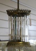 An early 20th century brass cylindrical hall lantern, with pierced gothic tracery and bevelled