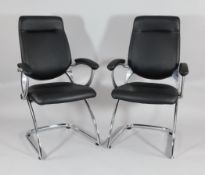 A pair of modern design chrome and black leather cantilever armchairs, unmarked