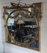 An early 19th century carved giltwood and gesso rectangular wall mirror, with floral garland crest