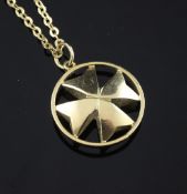 An 18ct gold circular pendant with cruciform centre, on 18ct gold chain, chain, 20.5in, 8 grams.