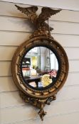 A Regency design giltwood gesso circular mirror, with eagle surmount