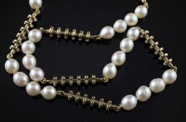 A modern gold and cultured pearl necklace, with stylised baton links, 24in. and a matching bracelet,