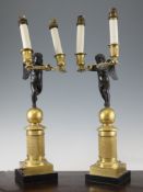 A pair of French Empire gilt bronze and bronze candelabra, 1ft 5.5in.