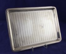 A Georg V silver dressing table tray, of rectangular form, with engine turned striped decoration,