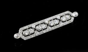 A 1920`s white gold and diamond bar brooch, of geometric design, 1.75in.