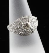 A Belle Epoque style platinum and diamond dress ring, the pierced setting with central stone