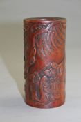 A Chinese boxwood small brush pot, carved in relief with three sages and an attendant in a rocky