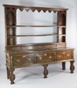 An 18th century oak dresser, with superstructure of five short drawers above three short drawers, on