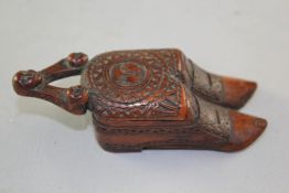 A late 18th century treen `twin shoe` snuff box, Dutch or English, carved with a sun motif and three