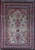 A Persian prayer rug, with central mirhab decorated with vase of flowers with borders of fish in a