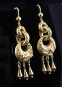 A pair of gold graduated triple hoop drop earrings, embossed with fish and crustaceans, each with
