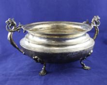 A late Victorian silver circular two handled tureen, the dragon handles with open work `flame`