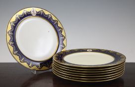 A set of eight Mintons porcelain armorial plates, c.1880, each painted with a triumphant lion