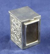 An Edwardian silver miniature playing card box, with repousse scroll decoration, divider and