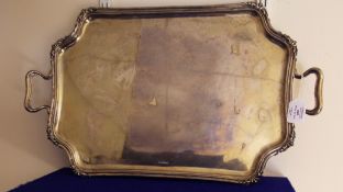 A George V silver two handled tea tray, of shaped rectangular form with re-entrant corners, George