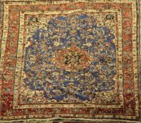 A Hamadan carpet, with central medallion in a field of scrolling foliage, on a blue ground, with