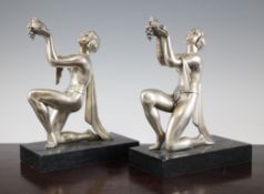 A pair of Art Deco spelter figural bookends, modelled as kneeling maidens, on marble bases, 10.5in.