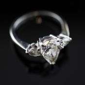 A platinum set pear shaped diamond ring, with central stone approximately 1.4ct. flanked by tear