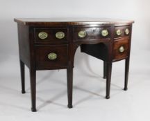 A George III mahogany bow front sideboard, with three drawers on tapered square legs, 2ft 10ins x