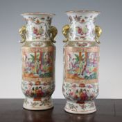 A pair of Chinese Canton decorated famille rose vases, late 19th century, each of cylindrical form