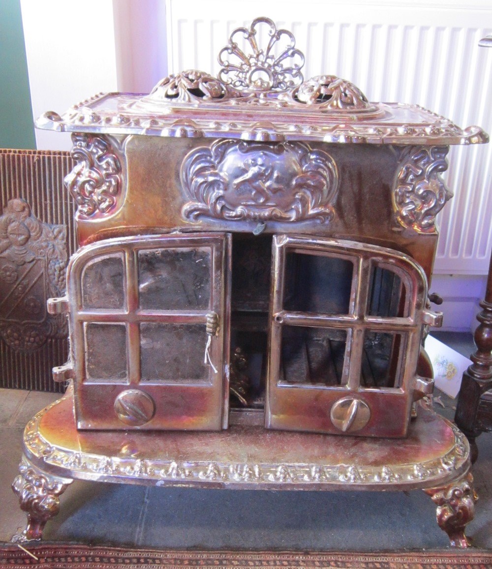 A cast `Dragon` woodburning Stove Model No. 2029-001 with lustre finish, the shaped base on four