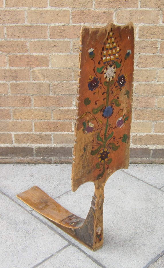 A Scandinavian painted treen article, possibly for wool winding, with floral decoration. Height 94