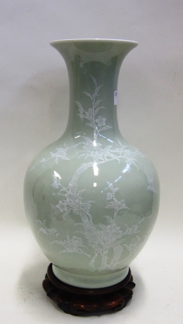 An Oriental Celadon Vase with white overlay foliate decoration, base drilled and with lamp