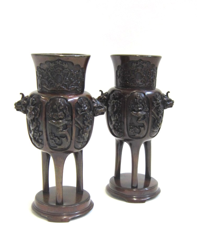 A pair of Japanese bronze tripod Koro. Decorated with panels of birds amongst foliage. 18 cms high