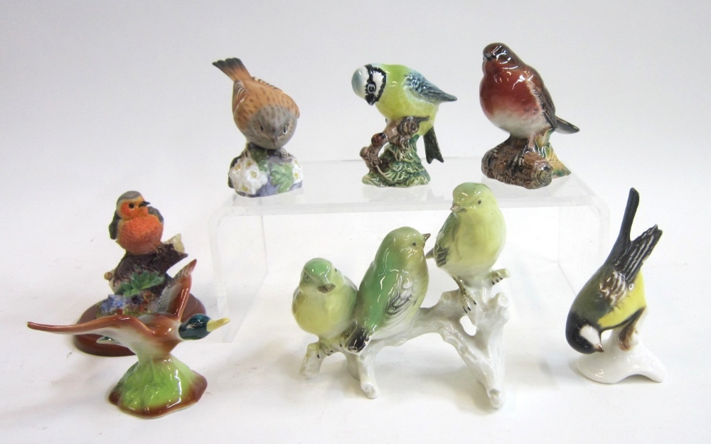 A Beswick Robin and Blue Tit, a Royal Worcester Hedge Sparrow and two Continental Groups of Green