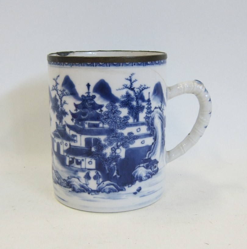 A Chinese Export blue and white Mug. Painted with a typical extensive landscape, with bamboo moulded