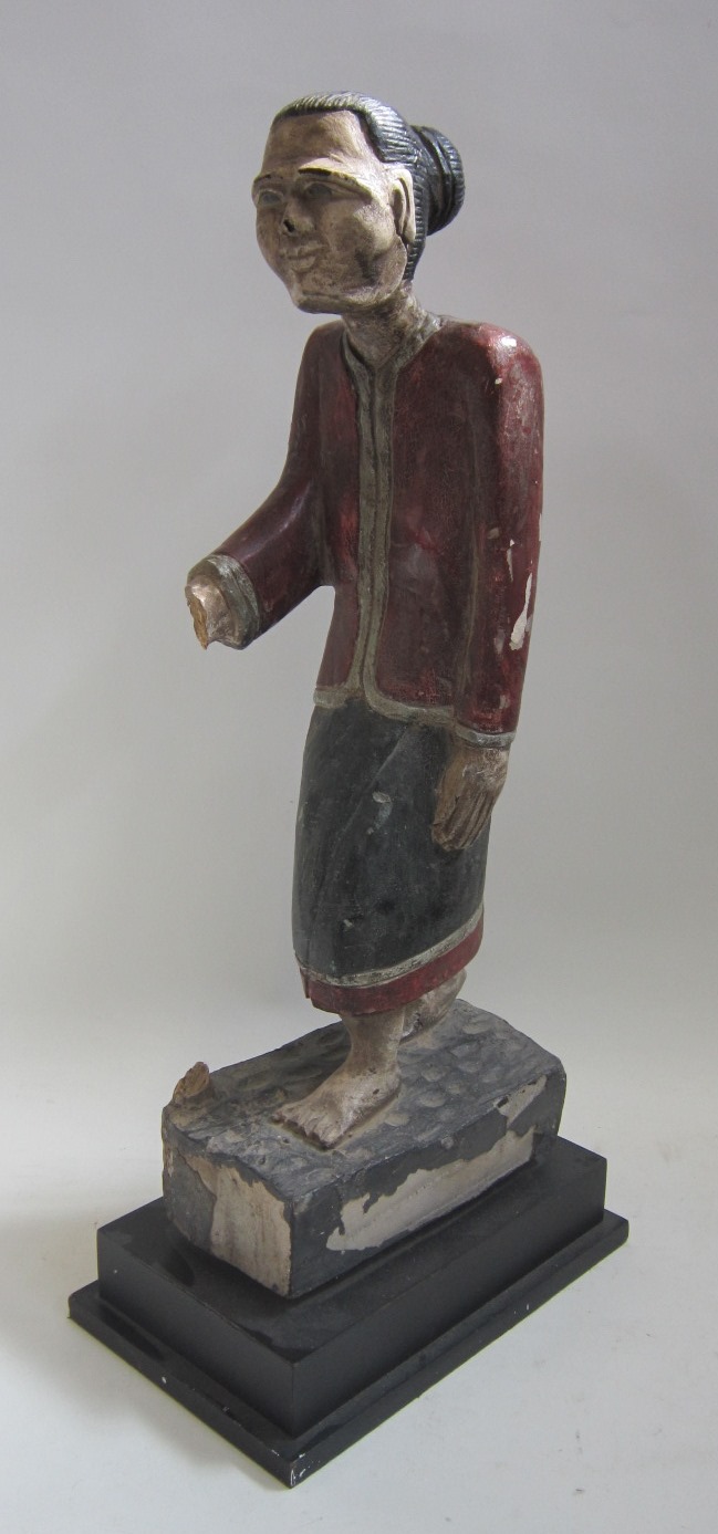 A polychrome carved Chinese Figure of a standing Gentleman on a stepped plinth base. Height 59 cms