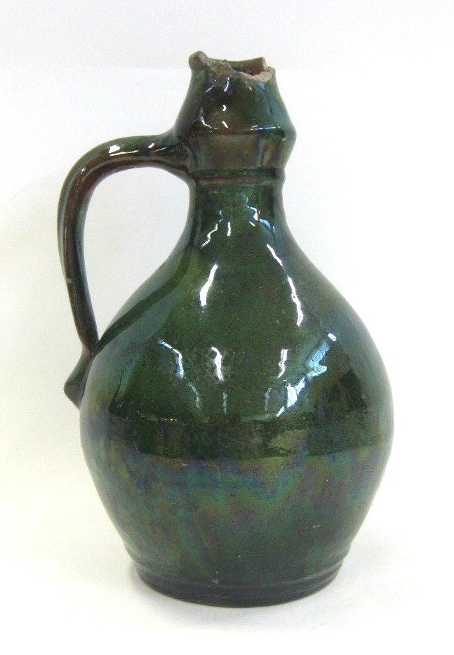 An E. B. Fishley Fremington Pottery green glazed Ewer/Jug, signed to base, 24 cms high (large rim