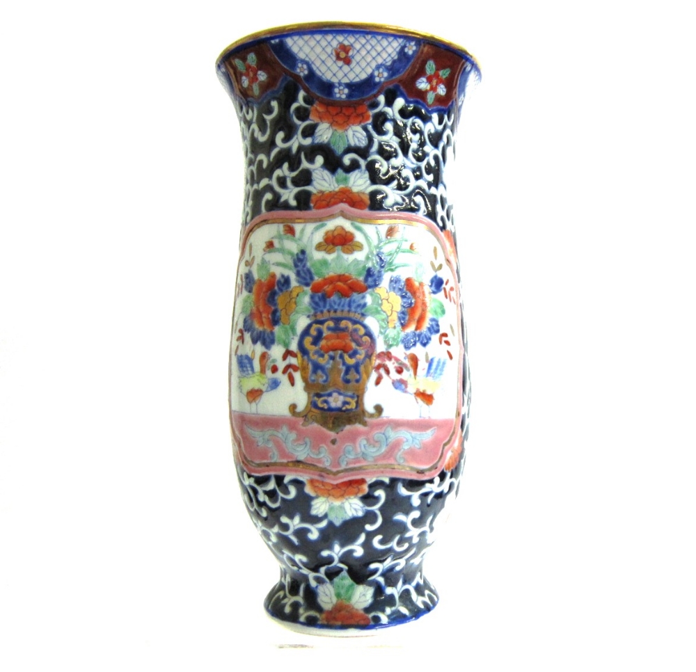 A Chinese porcelain Vase, decorated with a Vase of Flowers within a shaped reserve on a scrolling