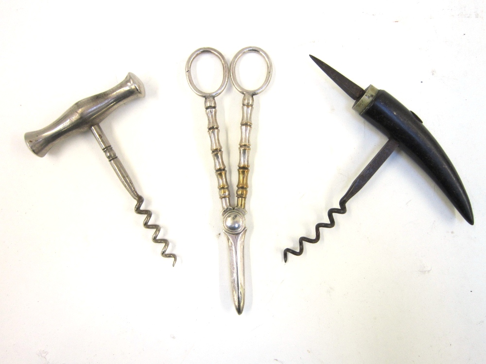 Two various pull Corkscrews; and a pair of electroplated Grape Scissors (3)