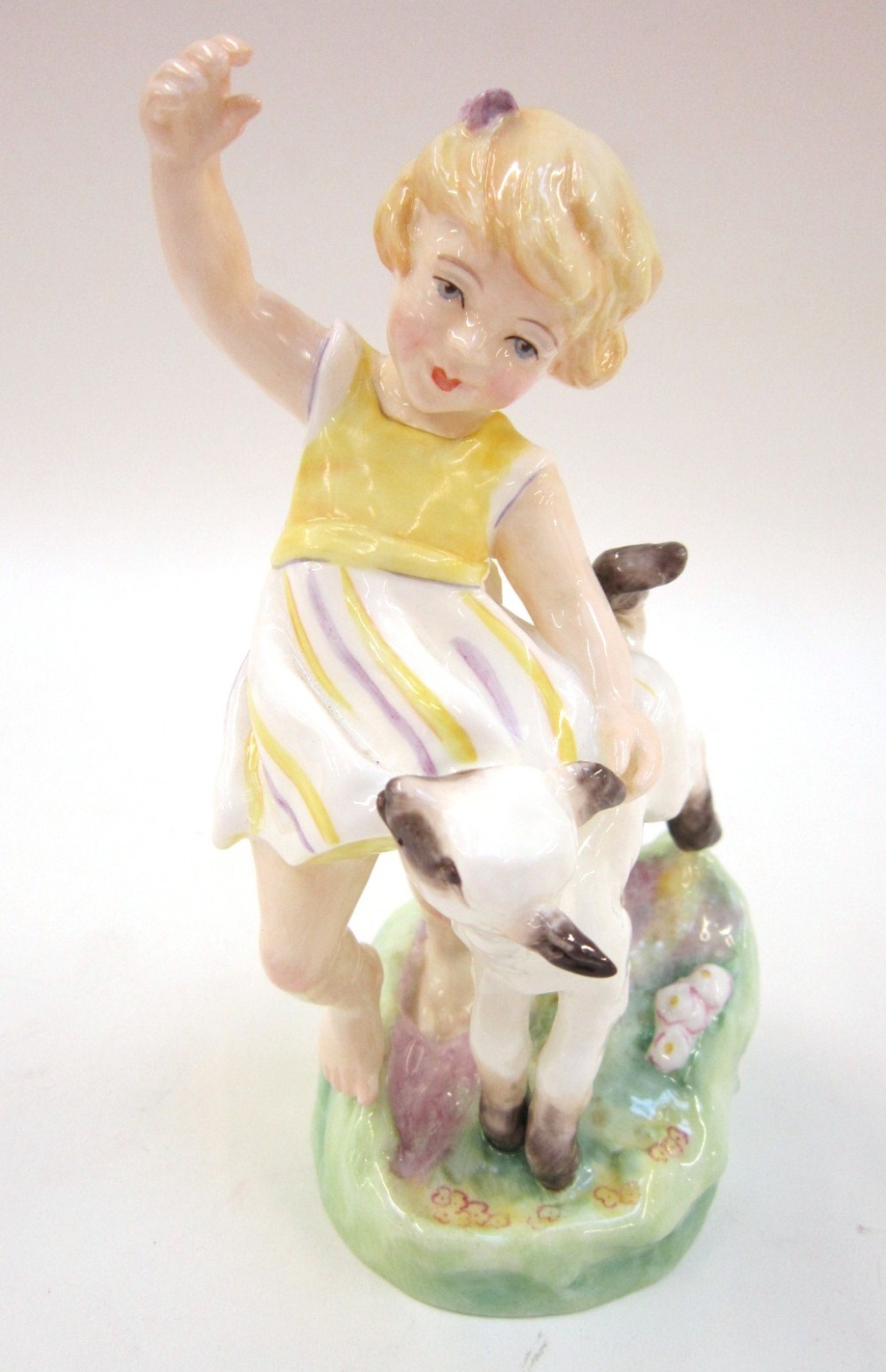 A Royal Worcester Figure `April`. No. 3416 of a young girl with a lamb, modelled by F G Doughty.