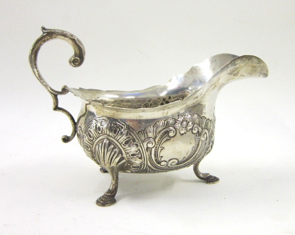 An Edwardian silver Sauce Boat of Georgian style. Mark of Williams Ltd, Birmingham, 1902. On three