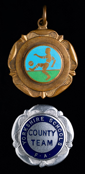 Two junior medals awarded to Cyril Knowles, a silver plated & enamel Yorkshire Schools F.A. County