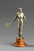 A silver patinated spelter figure of a gentleman tennis player, modelled about to hit a ball down