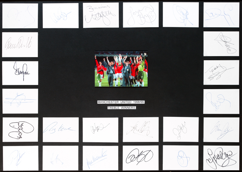 An autographed Manchester United 1999 Treble Winners display, mounted centrally with a photograph of