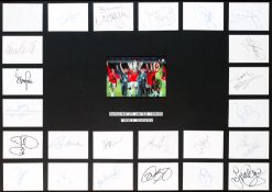 An autographed Manchester United 1999 Treble Winners display, mounted centrally with a photograph of