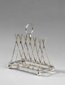 An electroplated toast rack designed with crossed golf clubs, length 16cm., 6 1/4in.