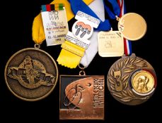 Miscellaneous cycling medals and badges awarded to Erika Salumae, including World Cycling