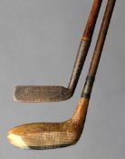 Two unusual patent putters, the first with a wooden head the top of which reaches a ridge in line