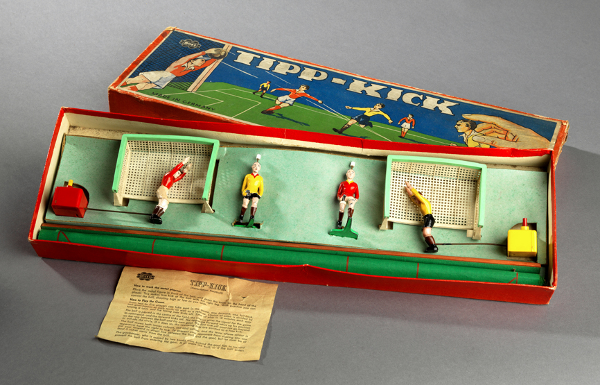 German football game "Tipp-Kick" by Mieg`s, original box containing four lead footballers, two