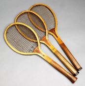 Three early 20th century convex throat tennis racquets, i) "Champion" by A.W.Gamage Ltd. of London